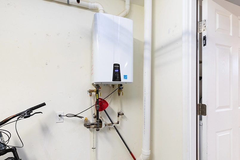 Tankless water heater hanging up on the wall of an O’Fallon, IL home.