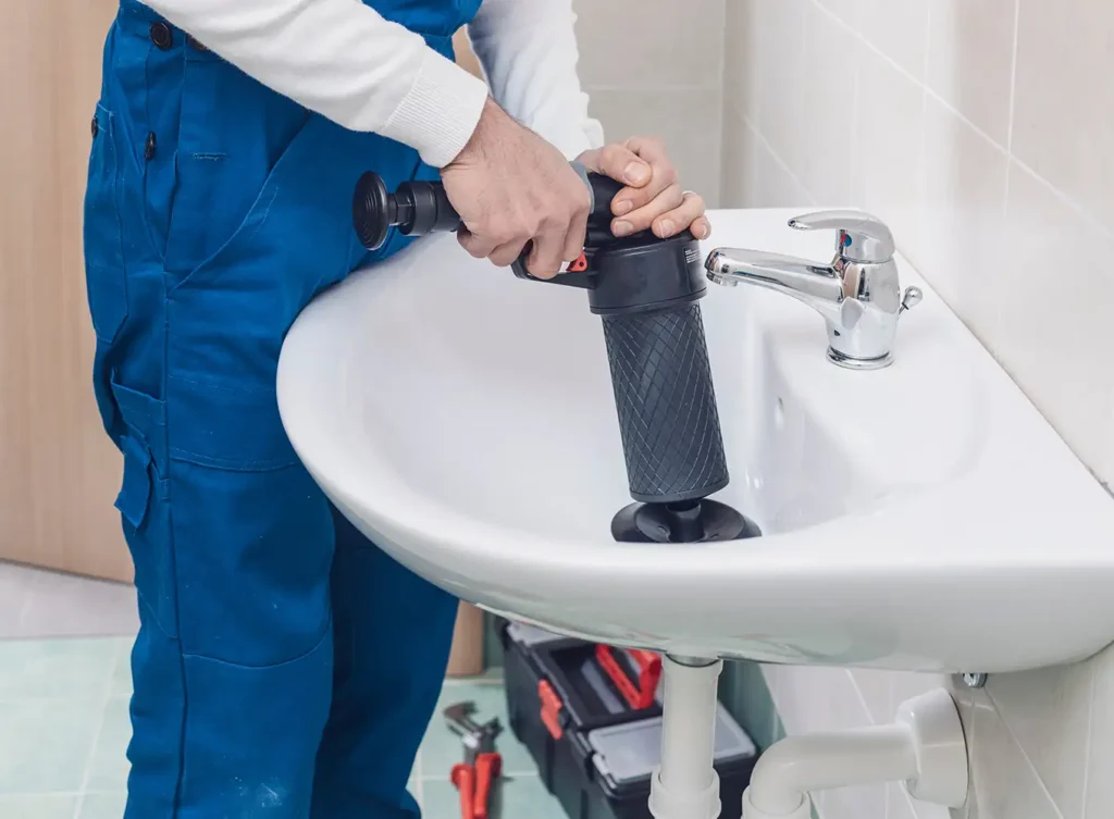 plumbing professional unclogging a drain collinsville illinois
