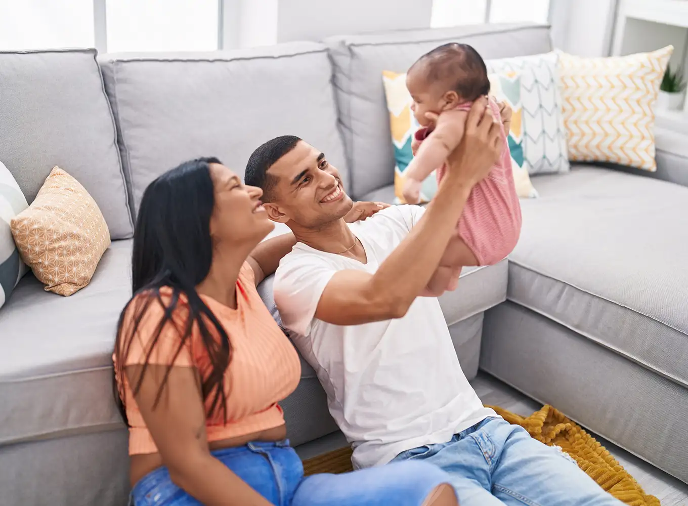 young family sitting on the floor in their comfortable home collinsville illinois