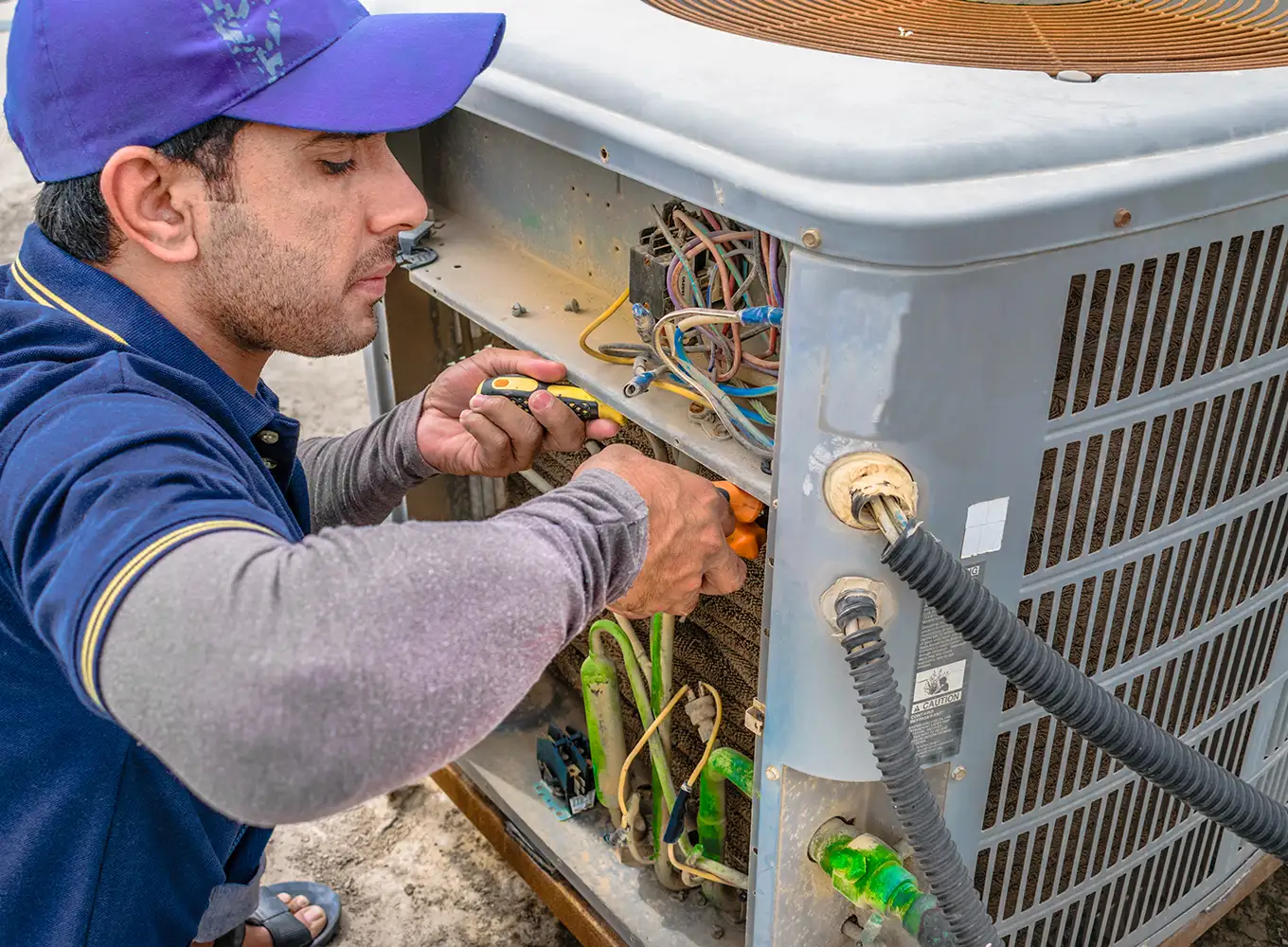 HVAC technician repairing an air conditioner in Collinsville IL