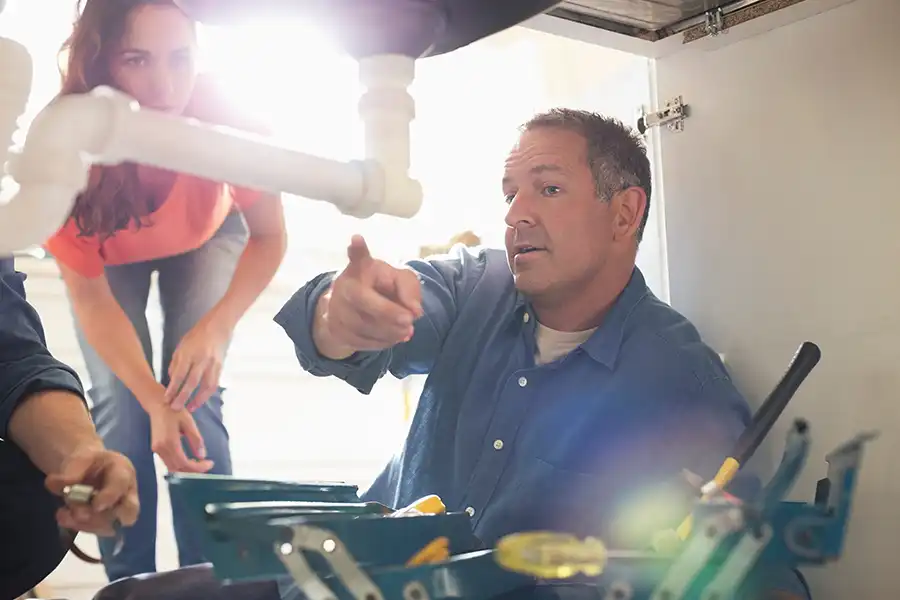 Polar plumbing technician providing efficiency consultation
