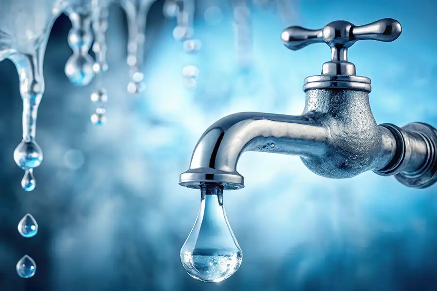 AI-generated dripping outdoor hose bibb - indicating a risk of frozen pipes and suggesting winter plumbing prep is needed in Collinsville IL.