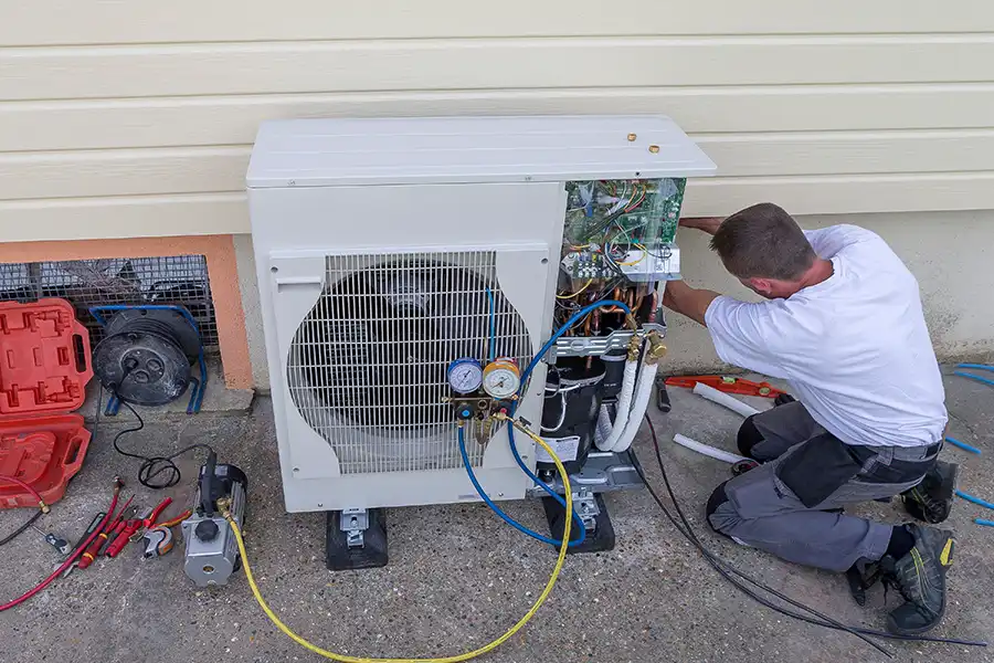 Polar—A male technician working on a circulation heat pump outside a home in O’Fallon, IL.