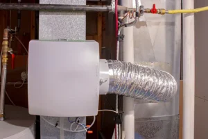 Polar—A whole-house humidifier attached to HVAC heating duct in a basement in a Collinsville, IL home.