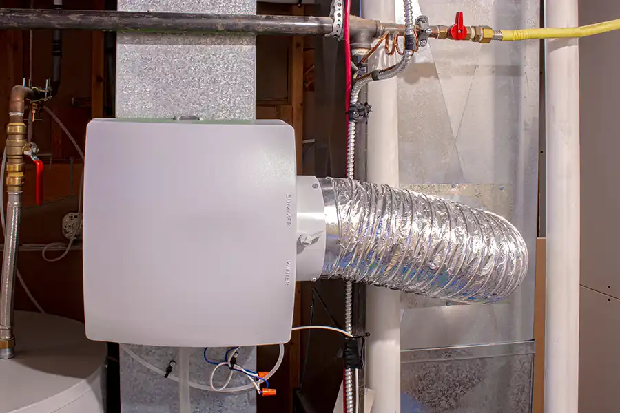 Polar—A whole-house humidifier attached to HVAC heating duct in a basement in a Collinsville, IL home.