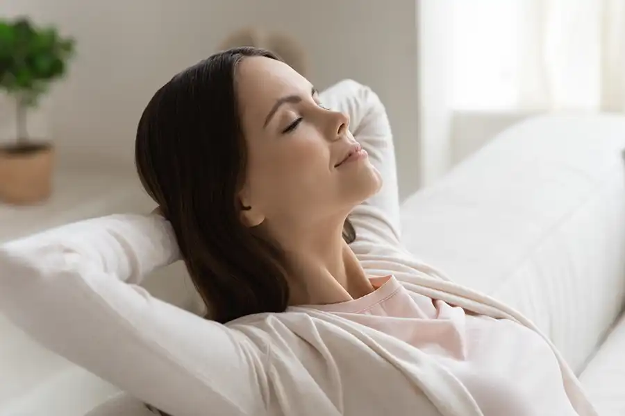 Polar – Women resting on the couch in her O’Fallon, IL home, breathing in clean air.