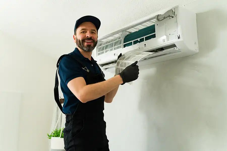 POLAR—An HVAC technician cleaning an air conditioner filter during maintenance service at a home in Collinsville, IL.