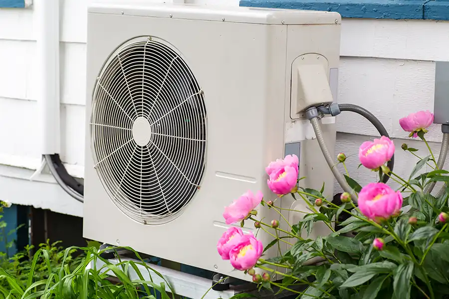 Polar—A heat pump outside of a home in O’Fallon, IL, surrounded by pink flowers.