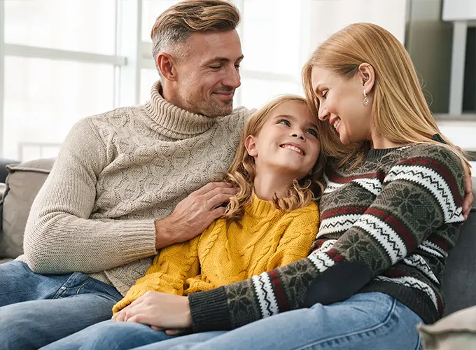 Family in Glen Carbon sitting on couch in Air Conditioning Comfort