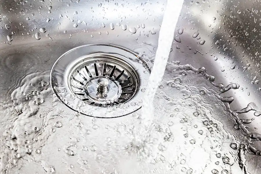 Polar—Water running down a clean drain in a sink in a Belleville, IL home.