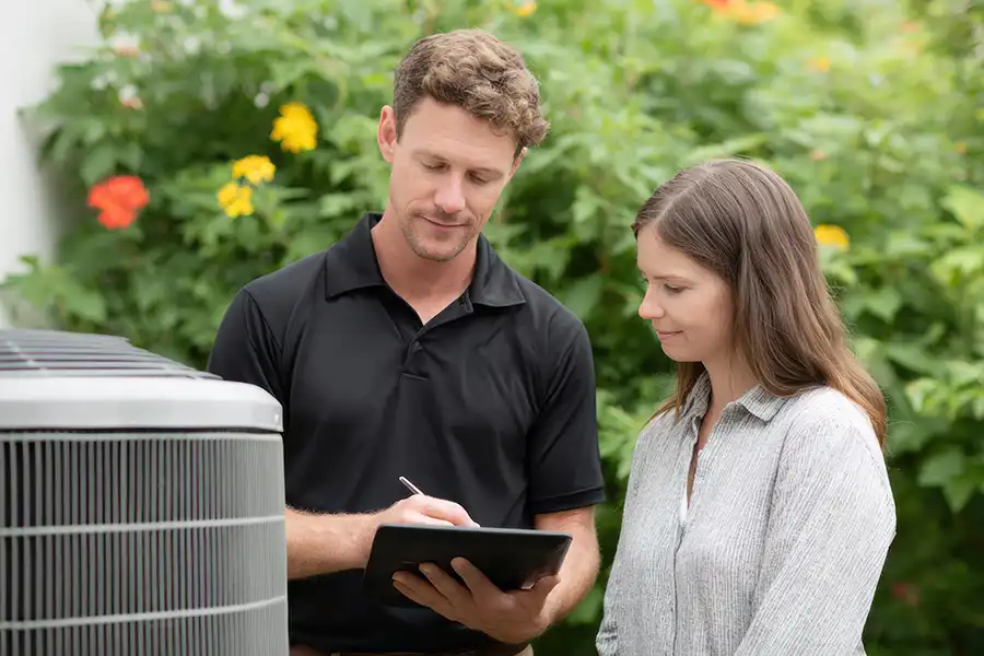 Polar—An HVAC technician helps a young homeowner sign up for an HVAC Maintenance Plan for her Belleville, IL home.